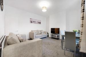 a living room with a couch and a tv at NEW! 4BR in Stanley in Annfield Plain