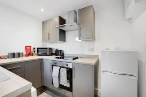 a kitchen with a stove and a refrigerator at NEW! 4BR in Stanley in Annfield Plain