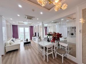 a living room with a table and chairs and a couch at Homestay Newlife Tower Vipp in Ha Long