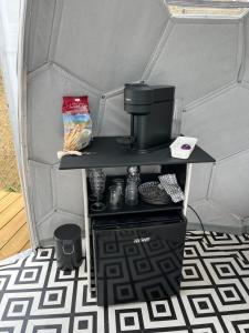 a coffee maker on a table in a tent at Dôme Nissaya in Nice