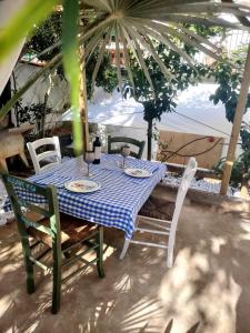 a table with chairs and a blue and white checkered table cloth at Aqua B7 in Cavo