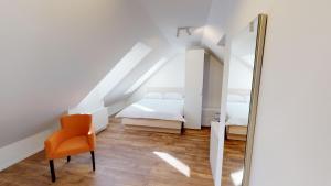 a bedroom with a mirror and a bed and a chair at Mestna Vila Krško in Krško
