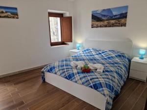 a bedroom with a bed with two stuffed animals on it at Dimore Rosantò 2 in Palombaro
