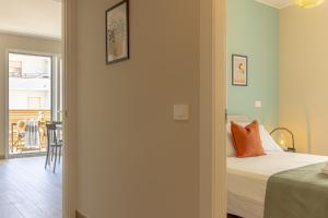 a bedroom with a bed and a table and a balcony at Appartamenti al Mare - Il Riparo d'aMare in Alba Adriatica +27 photos
