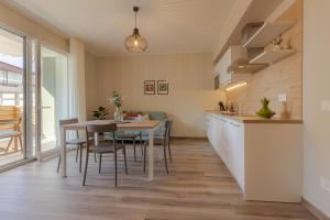 a kitchen and dining room with a table and chairs at Appartamenti al Mare - Il Riparo d'aMare in Alba Adriatica