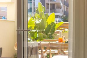 a table and chairs with a table and some plants at Appartamenti al Mare - Il Riparo d'aMare in Alba Adriatica