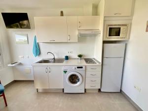 a kitchen with a washing machine and a refrigerator at Blue Oasis in Tacoronte