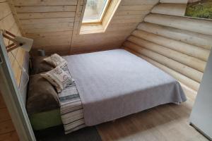 a small room with a bed and a window at Chatka pod lasem Szczyrk Domek z jacuzzi in Szczyrk