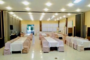 a banquet hall with white tables and white chairs at Alta Bohol Resort powered by Cocotel in Tagbilaran City