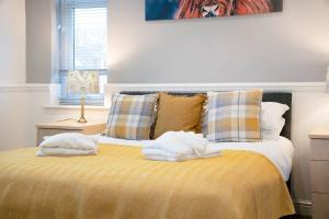 a bedroom with a bed with towels on it at NEW! 3BR in Haughton Road in Darlington