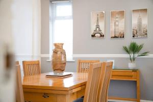 a dining room table with a vase on top of it at NEW! 3BR in Haughton Road in Darlington