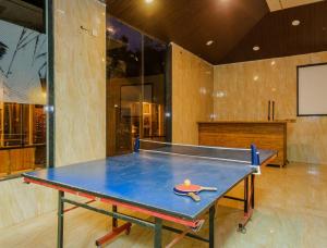 a ping pong table in a room with a tv at Blue Park Nature Resort in Mahabaleshwar
