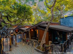 a house with a tree in front of it at Blue Park Nature Resort in Mahabaleshwar