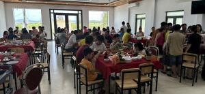a group of people sitting at tables in a restaurant at Đại Việt Hotel in Làng Liễu