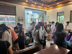 a crowd of people standing in a room at Đại Việt Hotel in Làng Liễu
