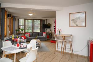 a living room with a couch and a table and chairs at Borálom Stúdió Apartman Tokaj in Tokaj