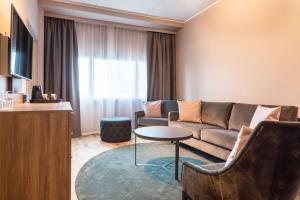a living room with a couch and a table at Scandic Helsinki Airport in Vantaa