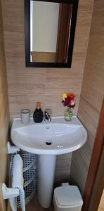 a bathroom with a white sink and a mirror at Casa Scirocco Sardegna in San Vito +17 photos