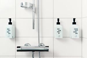a bathroom with a sink and two soap bottles at Scandic Veromies in Vantaa