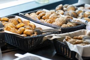 a bunch of donuts in baskets on a table at Scandic Veromies in Vantaa +6 photos