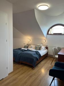 a bedroom with a large bed and a window at Kamienica przy Bramie in Opatów