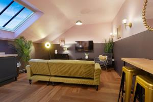 a living room with a couch and a tv at Chic Retreat with King Bed in Barnard Castle in Barnard Castle
