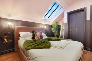 a bedroom with a large bed with a green blanket on it at Chic Retreat with King Bed in Barnard Castle in Barnard Castle