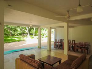 a living room with a couch and a table at Wilpattu Corridor Leisure in Wilpattu
