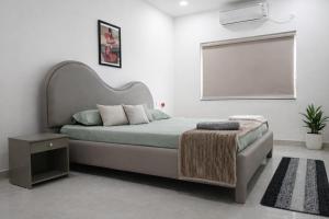 a bedroom with a large bed and a window at Chitrapuri - 3BHK Spacious Flat, Gachibowli Only for Families in Gachibowli