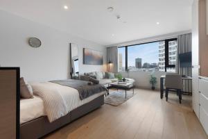 a bedroom with a large bed and a living room at Stylish Studio With Wi-Fi and Shared Spa Facilities in Manchester