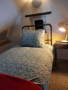 a bedroom with a bed with a pillow and a table at Domaine Bel Air 855 - Gîte Belle in Saint-Denis-de-Villenette +17 photos