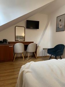 a bedroom with a bed and a desk and a mirror at Kamienica przy Bramie in Opatów