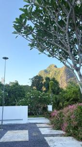a park bench with a mountain in the background at My Home Villa Phangnga in Phangnga