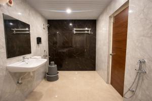 a bathroom with a sink and a shower at Chitrapuri - 3BHK Spacious Flat, Gachibowli Only for Families in Gachibowli +40 photos