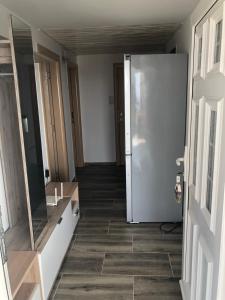 a hallway with a door and a tile floor at Viola Apartmans Lux in Šušanj +60 photos