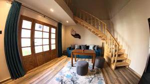 a living room with a blue couch and a wooden staircase at Villa golden life apartments, new property with pool access in Luxor +238 photos
