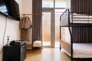 a bedroom with two bunk beds and a balcony at Connected Hotel Guro in Seoul +54 photos