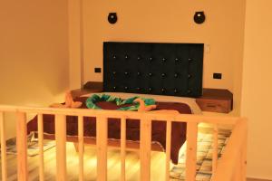 a crib in a room with a bed and aintendent at Villa golden life apartments, new property with pool access in Luxor