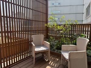 two chairs and a table on a deck at Connected Hotel Guro in Seoul