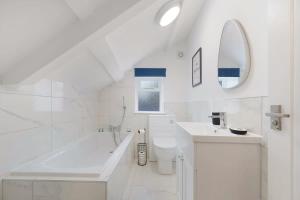 a white bathroom with a tub sink and a toilet at Flat3 1BR in Horsemarket in Barnard Castle