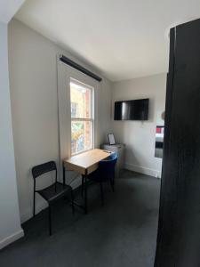 a room with a table and chairs and a window at Windsor Green Hotel in Melbourne