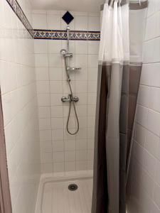 a bathroom with a shower with a shower curtain at le Cottage in Le Moule +13 photos