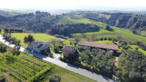 an aerial view of a farm with a building and a road at Agriturismo Il Fornello in Volterra