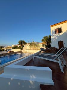 a house with a swimming pool next to a house at Villa Canario in Arboleas
