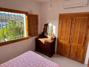 a bedroom with a bed and a mirror on a dresser at Villa Canario in Arboleas +39 photos