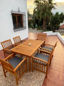 a wooden table and chairs on a patio at Villa Canario in Arboleas