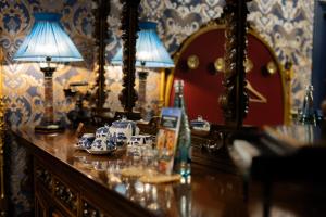 a dresser with a mirror and a lamp on it at Castle Boutique Hotel in Tirana