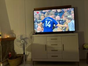 a flat screen tv sitting on top of a white cabinet at Villa Canario in Arboleas