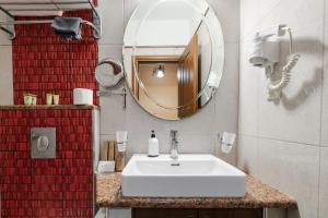a bathroom with a white sink and a mirror at Alsos House in Kalabaka +173 photos