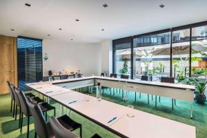 a restaurant with a pool and tables and chairs at Occidental Diagonal 414 in Barcelona +111 photos